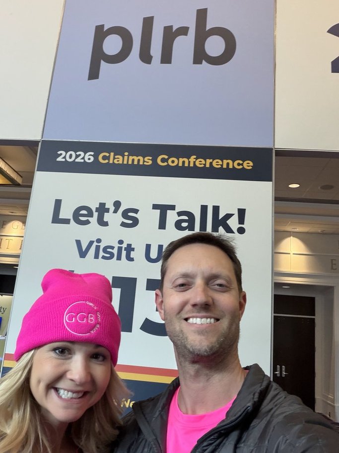Tarpers team members at the PLRB 2026 Claims Conference standing in front of the conference signage