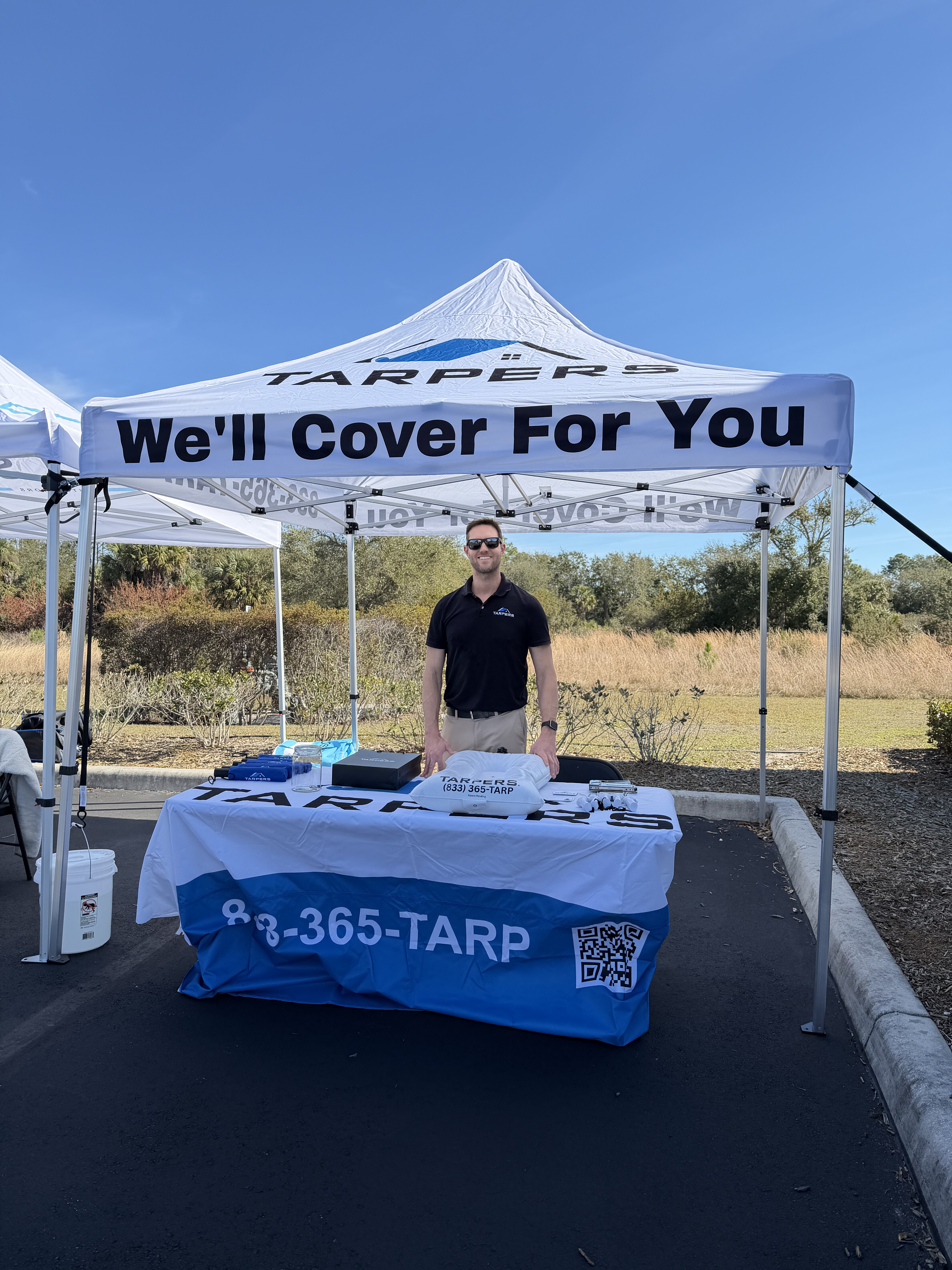 Tarpers booth at Security First Insurance Storm Response Showcase featuring branded tent with 'We'll Cover For You' tagline