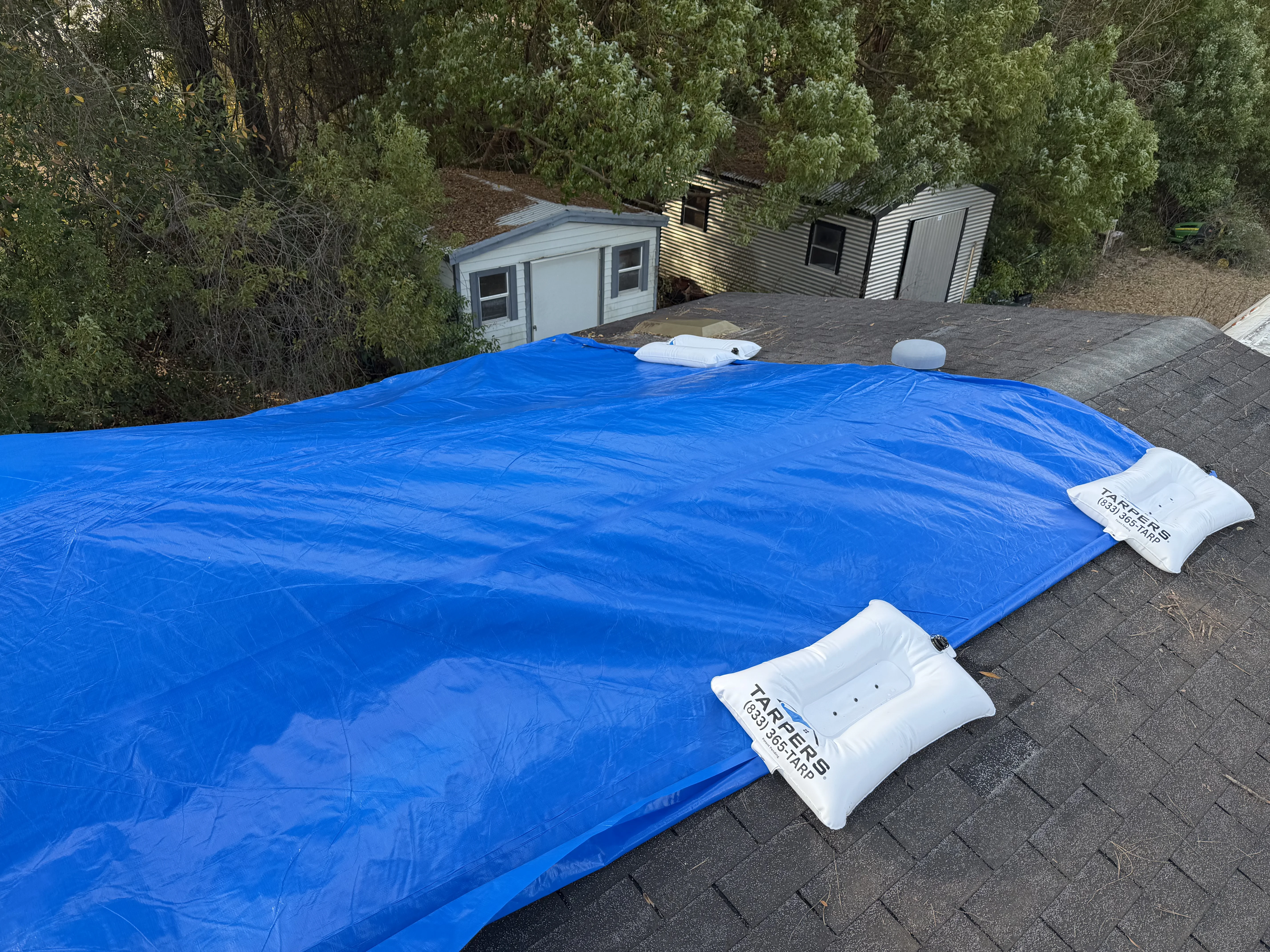 Insurance adjuster comparing tarping line items across Symbility and Cotality estimating platforms